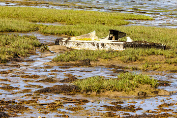 old boat broken on the sea estuary  