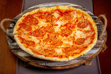 Hot pizza Diablo on a rustic wooden table. Italian food. Delicious homemade food