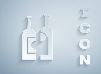 Paper cut Bottles of wine icon isolated on grey background. Paper art style. Vector Illustration.