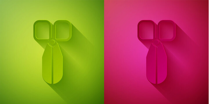 Paper cut Scissors icon isolated on green and pink background. Cutting tool sign. Paper art style. Vector Illustration.