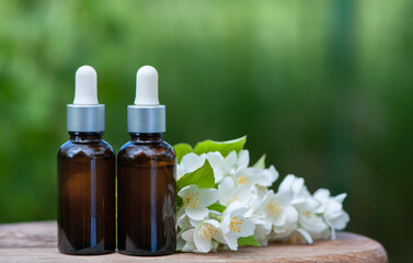 Obraz na płótnie Canvas Essential Jasmine oil. Bioproduct, organic cosmetics. Perfumery, cosmetology, aromatherapy