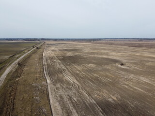 Dirt road in the fields, aerial view. Landscape.