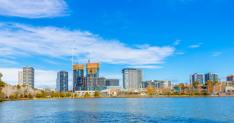 Naklejka premium Panoramic view of Belconnen town centre looking across Lake Ginninderra on a sunny day in Canberra, the capital of Australia 