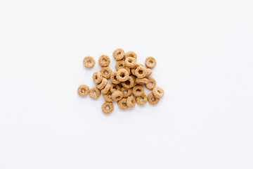 Handful of cereal cheerios in center on a white background.  