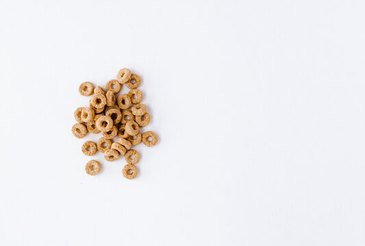 Few cheerios are scattered on white background on the right. Left blank space for signature