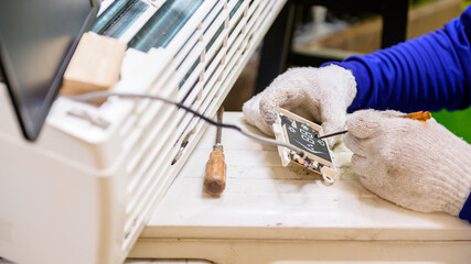 Asian man online learning and repair air conditioner at home. Social distancing and New normal...