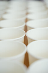 Coffee paper cups in a row. Background coffee to go.