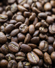 Full frame of aromatic roasted specialty coffee beans background