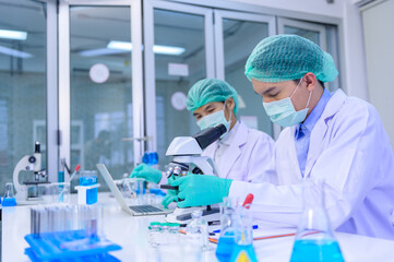 Scientist team researching Coronavirus cure in the laboratory. Asian Doctor working on vaccine...