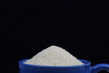 White Sugar in a cup , diabetes concept
