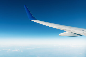 A panoramic top view from an airplan of the beautiful blue sky with clouds. Banner, wallpaper...