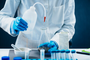 Pesticides in Tea. Quality Control Inspector Working with Herbal Tea Sample in Laboratory