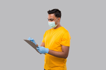 Indian Man Writing in clipboard Wearing Medical Mask and Gloves. Indian man Clipboard
