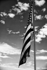 American flag against blue sky landscape, USA