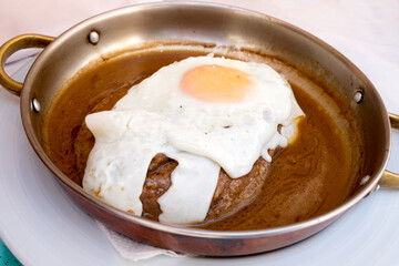 Delicious meat dish from Portugal food - juicy tenderloin steak with fried egg served in thick wine sauce