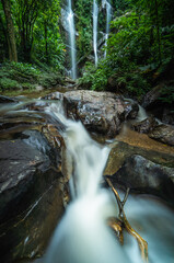 Tropical waterfall in rain forest at Mokfa Waterfall, Chiang Mai in North Thailand.