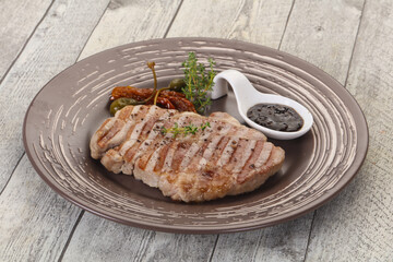 Grilled pork steak with pepper sauce