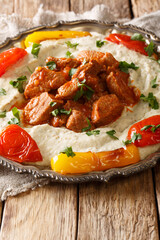 Alinazik kebab is a home-style Turkish dish which is a specialty of the Gaziantep province of Turkey closeup in the plate. vertical