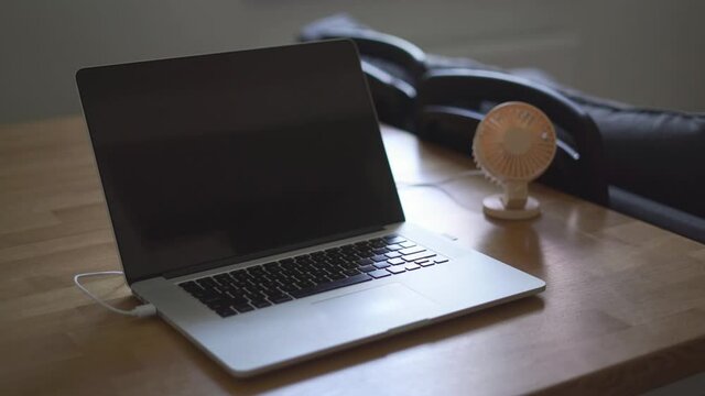 home office with usb min fan at home. quarantine working from home with laptop and fan
