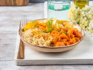 Vegan quinoa bowl with baked spiced pumpkin, fennel, bell pepper and turmeric. Healthy gluten free lunch or dinner