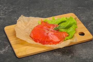 Sliced salmon fillet served rosemary