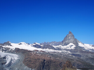 Matterhorn seen from the mountain climbed by the train in Zermatt on a sunny day.