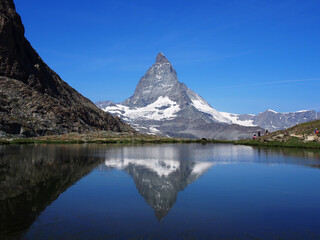 Matterhorn seen from the mountain climbed by the train in Zermatt on a sunny day.