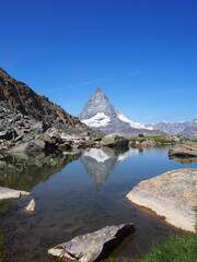 Matterhorn seen from the mountain climbed by the train in Zermatt on a sunny day.