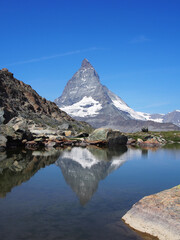 Matterhorn seen from the mountain climbed by the train in Zermatt on a sunny day.