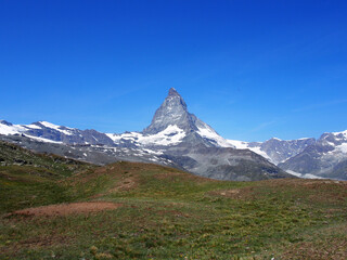 Matterhorn seen from the mountain climbed by the train in Zermatt on a sunny day.