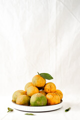 An empty cup is placed on a ceramic plate with coffee bean ornaments and a vase.