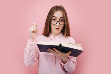 Beautiful young lady in eyewear capturing new ideas that appear in her head during reading...