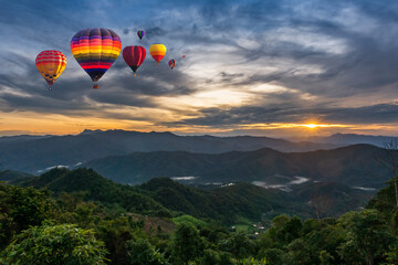 Colorful Hot Air Balloons over mountain in sunrise in forest, Chiang Mai in Thailand