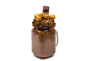 Chocolate milkshake with whipped cream, cookies, waffles, served in glass mason jar. 