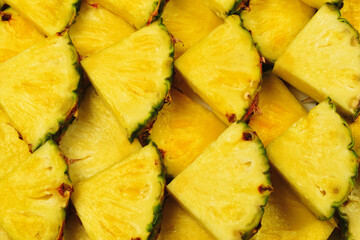 Pineapple juicy yellow slices background. Top view.
