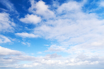 Naklejka na ściany i meble White cumulus clouds in blue sky at day