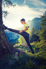 Obraz premium Sport activities in the nature improve health and well-being. Active young athlete running and stretching high in the mountains.
