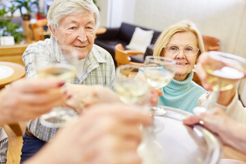 Senioren Paar feiert mit einem Glas Weißwein Geburtstag oder Hochzeitstag