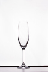 Empty champagne glass isolated on white. Clean transparent cup for alcoholic drinks.