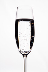 Transparent drink with bubbles isolated on white. Close up alcohol cocktail in a champagne glass cup.