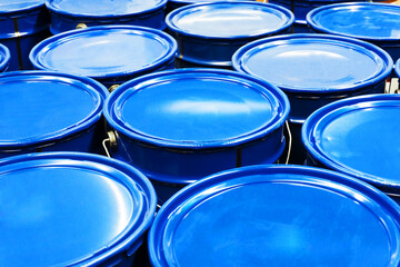 Blue metal buckets. Trade in paint in a building materials store.
