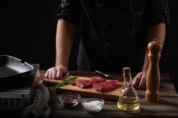 the chef is about to marinate the beef steak