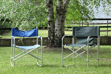 relax concept: two empty chairs in a garden at sunset with copy space for your text