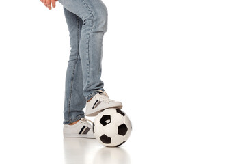 cropped view of man in jeans playing football on white