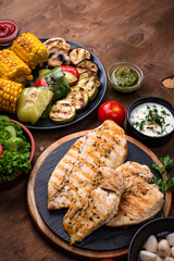 Grilled sausages, meat, and vegetables.
