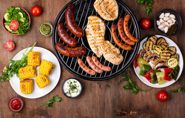 Grilled sausages, meat, and vegetables.