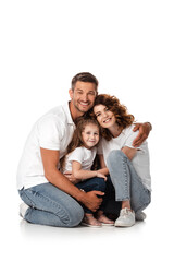 happy man hugging wife and daughter on white