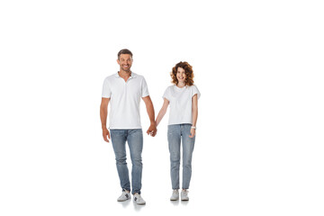 Fototapeta premium happy woman and cheerful man holding hands and standing on white