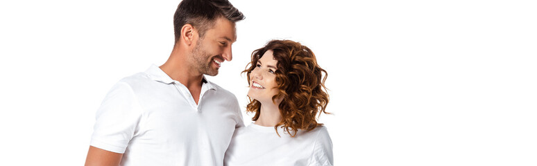 panoramic concept of happy husband and wife looking at each other isolated on white