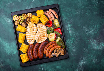 Grilled sausages, meat, and vegetables.